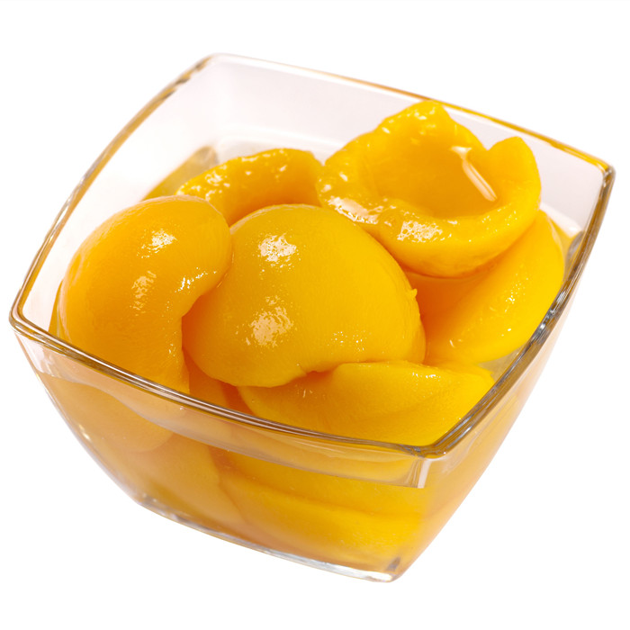 Canned peach halves in tin